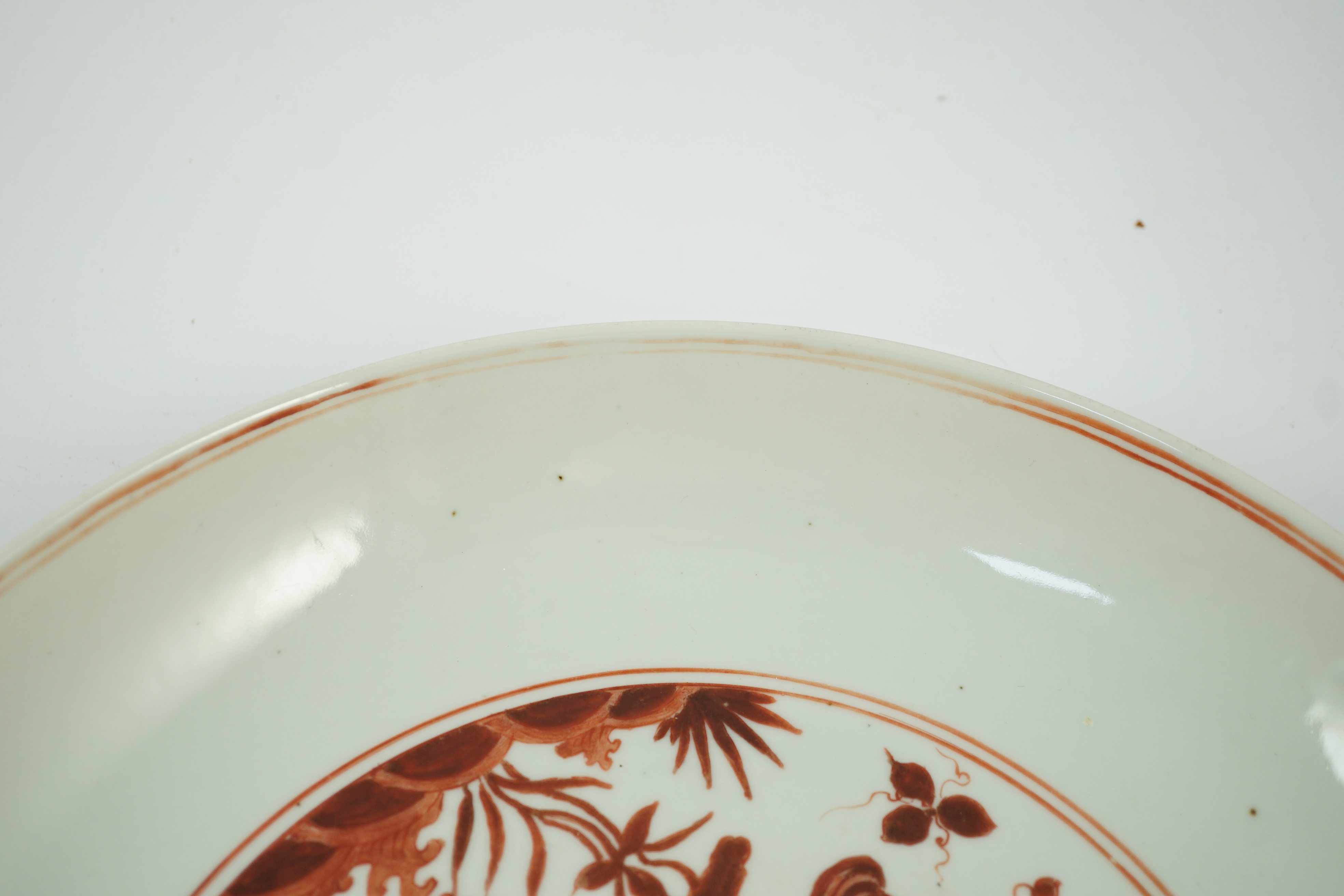 A large Chinese iron red enamelled ‘lotus pond’ dish, Wanli mark and possibly of the period, two short cracks
